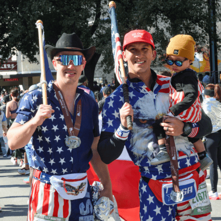 Three people in American flag outfits holding flags Three people in American flag outfits holding flags