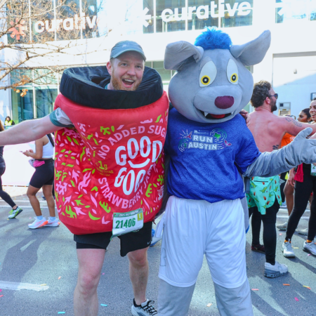 Runner in strawberry costume with mouse mascot Runner in strawberry costume with mouse mascot