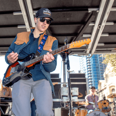 Guitarist performing on outdoor urban stage Guitarist performing on outdoor urban stage