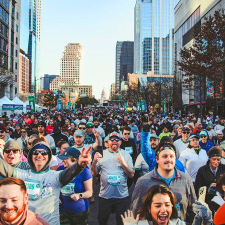 Crowd running a downtown city marathon Crowd running a downtown city marathon