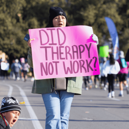 Person holding pink sign "Did therapy not work? Person holding pink sign "Did therapy not work?