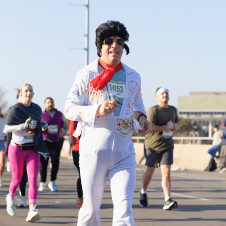Runner dressed as Elvis in white jumpsuit Runner dressed as Elvis in white jumpsuit