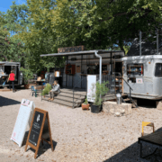 Outdoor coffee trailer with seating and menu boards