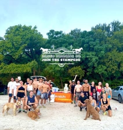 Group of runners and dogs at outdoor event Group of runners and dogs at outdoor event