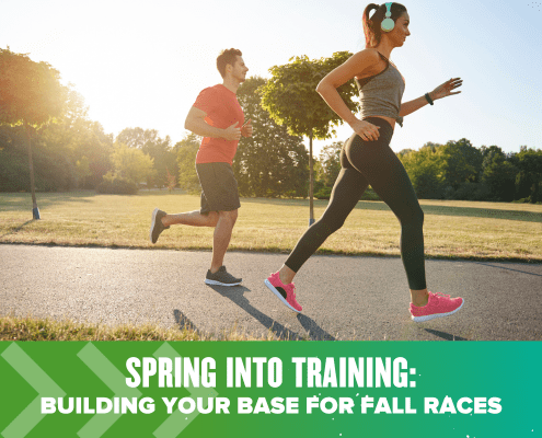 Pair of runners training on sunny park path