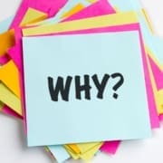 A stack of colorful paper sheets with a blue sheet on top that has "WHY?" in bold black letters—perfect inspiration for any beginner runner creating their runner checklist or starting their journey running for beginners. Austin Marathon Half Marathon & 5K