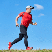 Runner in red shirt jogging outdoors