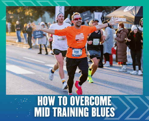 A smiling runner in an orange shirt raises his arms in celebration while running a race with other participants. The text at the bottom reads, "How to Overcome Training Slump. Austin Marathon Half Marathon & 5K
