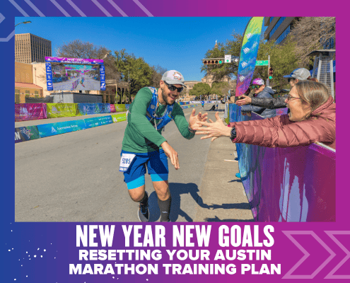 A runner high-fives a supporter during the Austin Marathon. Bright banners and spectators line the street. Text at the bottom reads, “New Year New Goals: Resetting Your Austin Marathon Training Plan for New Year fitness.”. Austin Marathon Half Marathon & 5K