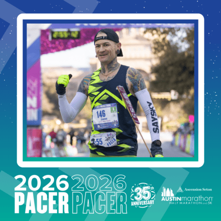 A smiling runner wearing a race bib and a