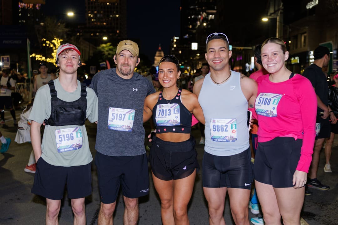 Group of five runners posing on city street Group of five runners posing on city street