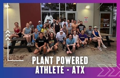 A large group of people in athletic wear smile and pose together outside a building with glass doors, representing the Buda Running Club. Text at the bottom reads, "Plant Powered Athlete - ATX." The border is purple and blue with white graphic arrows. Austin Marathon Half Marathon & 5K