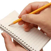 A person holding a small spiral notebook in one hand and writing on a blank, lined page with a yellow pencil in the other, jotting down their Next Big Goal to boost Running Motivation after tackling the Post-Race Blues. Austin Marathon Half Marathon & 5K