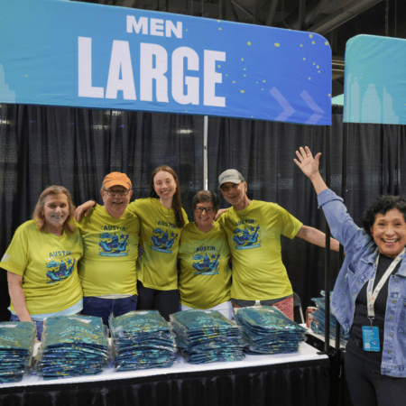 Volunteers selling Austin t-shirts at booth