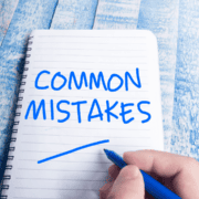Hand writing "COMMON MISTAKES" in notebook