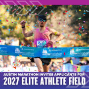 A runner crosses the Austin Marathon finish line under falling confetti, wearing sunglasses and a pink top. Banner text reads: "Austin Marathon invites applicants for the 2027 Elite Athlete Program. Austin Marathon Half Marathon & 5K