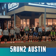 A large group of runners poses together at night outside a brightly lit cafe in Austin, celebrating KickOff Week with a spirited group run. Text at the bottom reads “5RUN2 AUSTIN.” Bat icons decorate the corners of the image. Austin Marathon Half Marathon & 5K