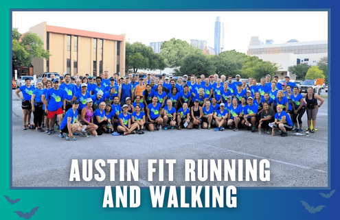 A large group of people in matching blue shirts pose outdoors for a group photo, celebrating a successful Group Run. Text at the bottom reads “Austin Fit Running and Walking.” Buildings and trees form the perfect backdrop, capturing the vibrant spirit of South Austin. Austin Marathon Half Marathon & 5K