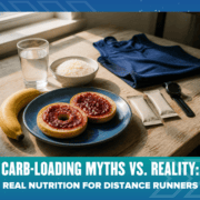 A plate with jam-topped bagels, a banana, rice, bars, water, a blue shirt, and a sports watch on the table. Text: “Carb-Loading Myths vs. Reality: Real Nutrition for Distance Runners.”. Austin Marathon Half Marathon & 5K