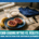 A plate with jam-topped bagels, a banana, rice, bars, water, a blue shirt, and a sports watch on the table. Text: “Carb-Loading Myths vs. Reality: Real Nutrition for Distance Runners.”. Austin Marathon Half Marathon & 5K