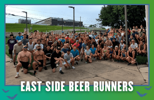 A large group of people pose outdoors in athletic wear, gathered closely together, smiling at the camera. Text at the bottom reads “EAST SIDE BEER RUNNERS” on a teal border with small bats. This vibrant South Austin group run captures the spirit of Rise and Run—friends coming together for fitness and fun. Austin Marathon Half Marathon & 5K