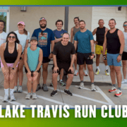 A group of thirteen people in athletic wear smile outside a building, posed for a group run. Text at the bottom reads āLake Travis Run Clubā over a green and blue border with bat graphics, highlighting the kickoff week atmosphere reminiscent of the Leanderthal Runners Club spirit. Austin Marathon Half Marathon & 5K