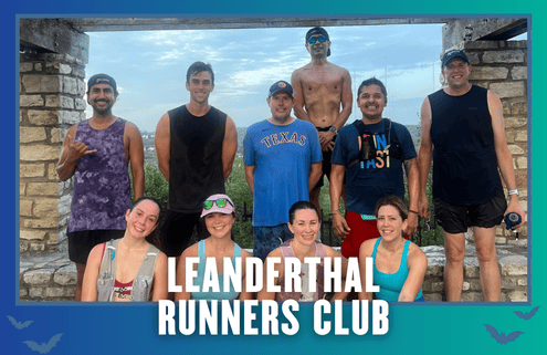 Nine sweaty runners, smiling and posing under a stone arch with greenery behind them after a spirited group run. Most are wearing running gear and hats. The words “LEANDERTHAL RUNNERS CLUB” appear at the bottom, with a blue border and bat silhouettes, capturing the energetic spirit of Austin’s running community. Austin Marathon Half Marathon & 5K