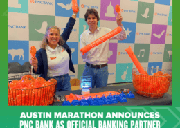 Two people smiling behind a table with PNC Bank swag at the Austin Marathon Health & Fitness Expo. Banners and orange promo items are displayed, with text announcing PNC Bank as the marathon’s official banking partner. Austin Marathon Half Marathon & 5K