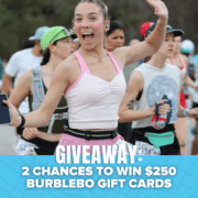 A smiling woman in athletic wear holds a phone and runs in a race with others, all hoping to win big. Text at the bottom reads, “GIVEAWAY: 2 CHANCES TO WIN $250 BURBLEBO GIFT CARDS.” Blue background has small bats, setting the scene for an exciting Neversecond Marathon Race Packs giveaway. Austin Marathon Half Marathon & 5K