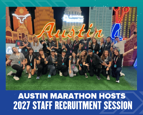 A group of Austin Marathon staff members posing for a photo in front of an Austin-themed display, with text below reading “Austin Marathon Hosts 2027 Staff Recruitment Session.” Austin Marathon Half Marathon & 5K